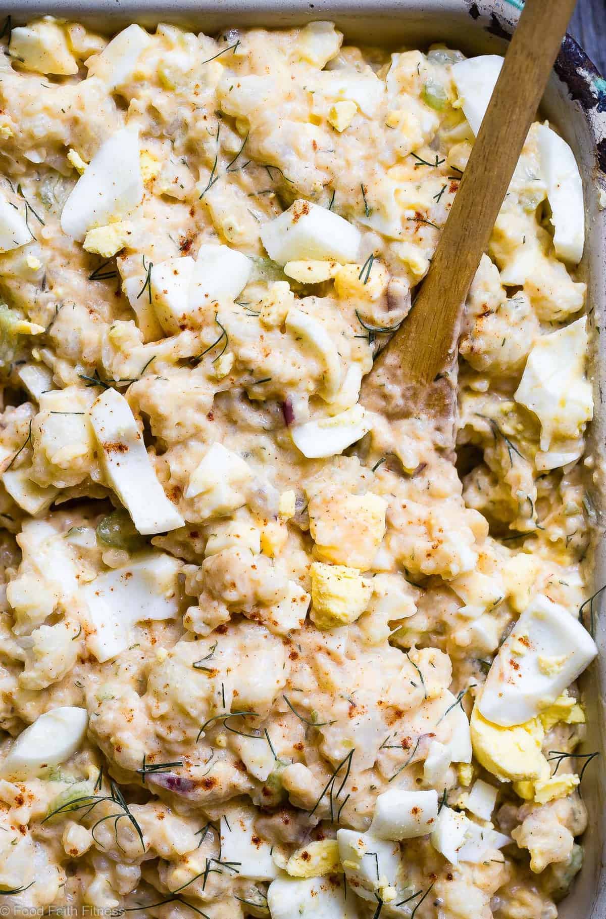 Low Carb Cauliflower Potato Salad - This keto, paleo and whole30 Cauliflower Potato Salad tastes EXACTLY like the classic potato salad without the carbs! Everyone will be fooled by this healthy comfort food! | #Foodfaithfitness | #Paleo #Keto #Glutenfree #Lowcarb #Whole30 close up of Cauliflower Potato Salad in a serving dish