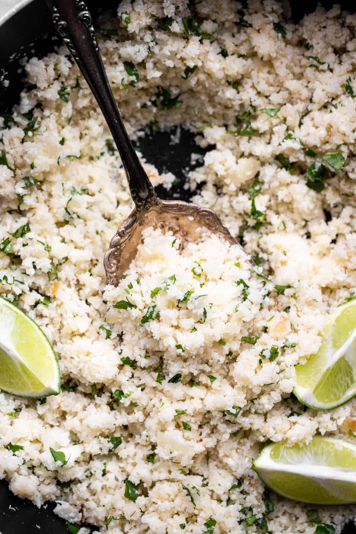 Cilantro Lime Cauliflower Rice - This Cilantro Lime Cauliflower Rice is an easy, 5 ingredient recipe that is a healthy, gluten free and low carb side dish for the whole family! | #Foodfaithfitness | #Keto #Lowcarb #glutenfree #paleo #whole30 overhead of a skillet filled with cilantro lime cauliflower rice