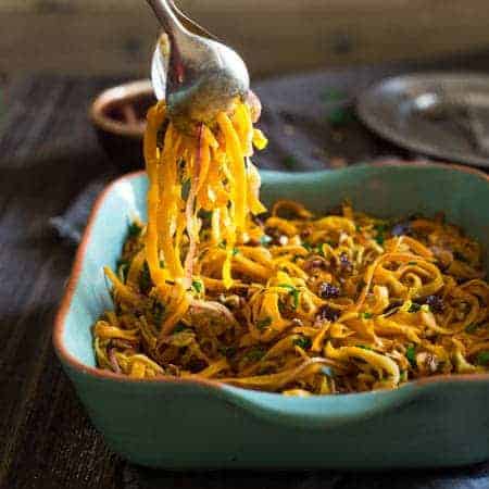 Paleo & Vegan Curried Maple Spiralized Apple and Butternut Squash Salad - This salad is full of apples, dates and pecans. It has a spicy-sweet flavor and is a healthy, paleo and vegan friendly side dish! Perfect for Thanksgiving! | Foodfaithfitness.com | @FoodFaithFit