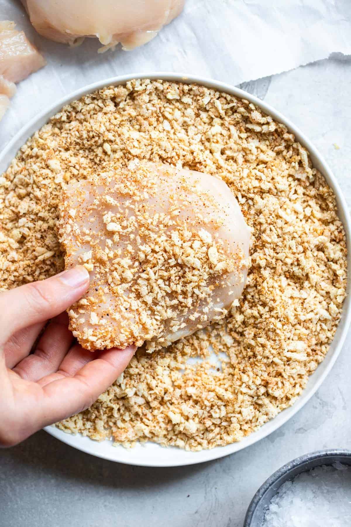 Crispy Breaded Air Fryer Chicken Breast - SO crispy you won't believe how healthy and easy it is to make! Great for busy weeknights and for picky eaters! There is a gluten free option included! | #Foodfaithfitness | #Glutenfree #Healthy #Kidfriendly #Airfryer #Nutfree Air Fryer Breaded Chicken Breast being breaded