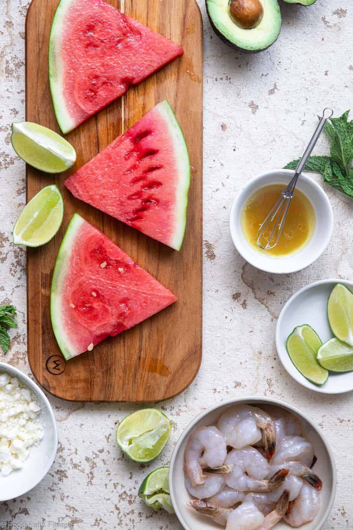 Shrimp Avocado Salad with Watermelon - An easy, healthy Summer dinner that is light and refreshing! Naturally gluten free, protein packed, under 300 calories and SO tasty! | #Foodfaithfitness | #Glutenfree #healthy #grainfree #watermelonĀ sliced watermelon arranged on a cutting board