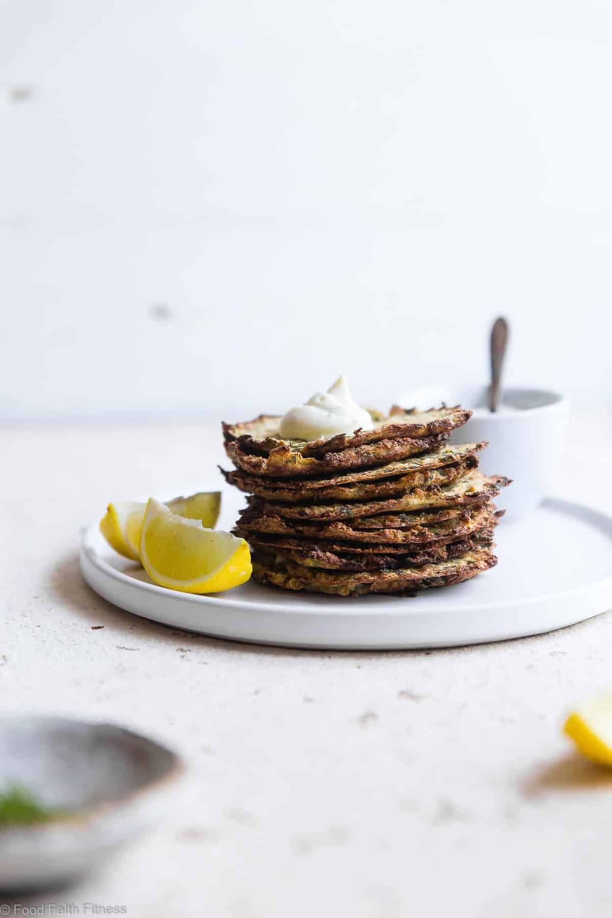 Paleo Baked Zucchini Fritters - These EAS, keto Baked Zucchini Fritters are served with an addicting lemon dill drop and are SO crispy, you'll never believe they're baked not fried! Gluten free, low carb, whole30 and insanely tasty! | #Foodfaithfitness | #Glutenfree #keto #Paleo #Whole30 #Lowcarb Paleo Baked Zucchini Fritters - These EAS, keto Baked Zucchini Fritters are served with an addicting lemon dill drop and are SO crispy, you'll never believe they're baked not fried! Gluten free, low carb, whole30 and insanely tasty! | #Foodfaithfitness | #Glutenfree #keto #Paleo #Whole30 #Lowcarb